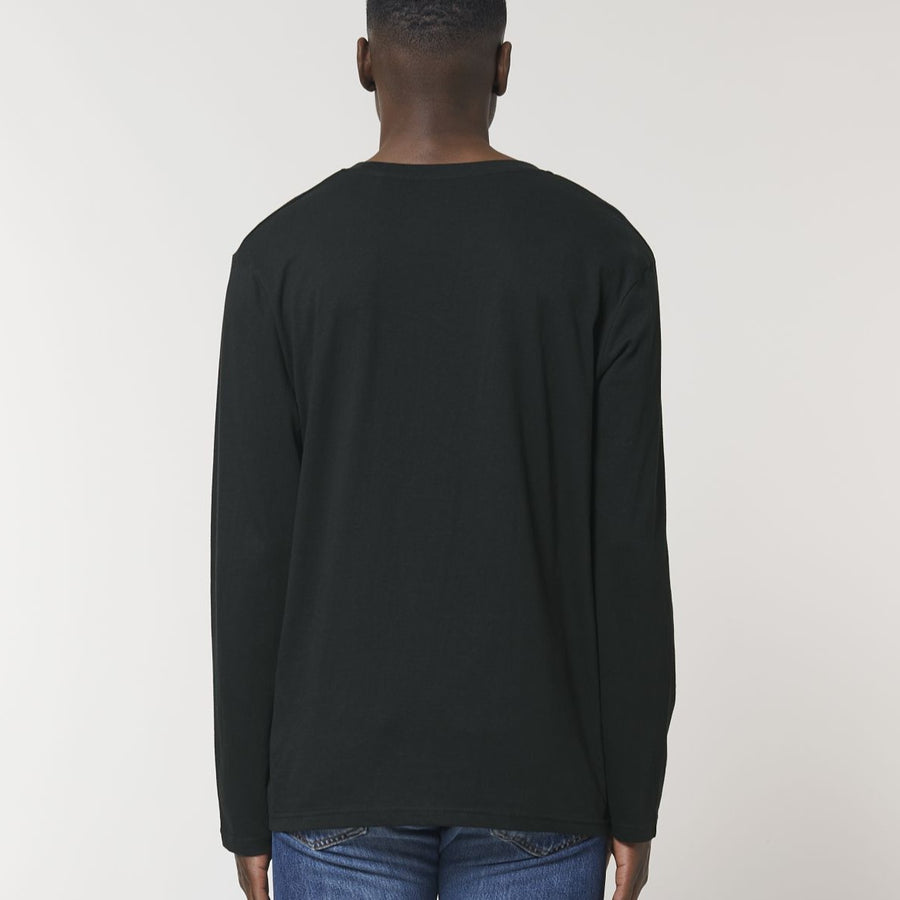 A back view of a model wearing a black Stanley/Stella Shuffler organic cotton long sleeve T-Shirt