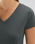A female model wearing a Stanley/Stella Ladies anthracite evoker v neck T-Shirt
