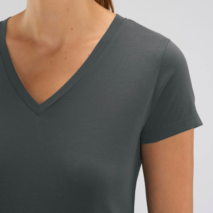 A female model wearing a Stanley/Stella Ladies anthracite evoker v neck T-Shirt