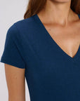 A front detail view of a female model wearing a Stanley/Stella Ladies heather blue evoker v neck T-Shirt