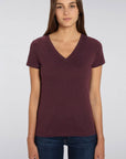 A female model wearing a Stanley/Stella Ladies burgundy evoker v neck T-Shirt