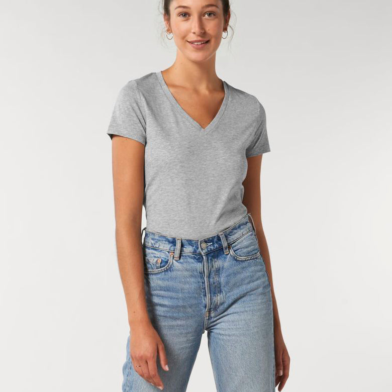 A female model wearing a Stanley/Stella Ladies heather grey evoker v neck T-Shirt