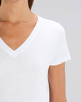 A front detail view of a female model wearing a Stanley/Stella Ladies white evoker v neck T-Shirt